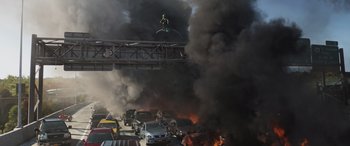 Movie still from “Spider-Man: No Way Home” (2021), directed by Jon Watts – A man flying through the air while standing on top of a bridge; Extreme Wide shot, High angle