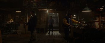 Movie still from “Spider-Man: No Way Home” (2021), directed by Jon Watts – A group of people standing in front of a staircase; Wide shot, Low angle