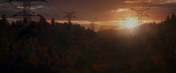 Movie still from “Spider-Man: No Way Home” (2021), directed by Jon Watts – The sun is setting over a wooded area with power lines; Extreme Wide shot, Low angle