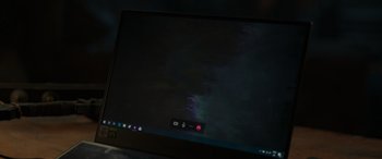Movie still from “Spider-Man: No Way Home” (2021), directed by Jon Watts – A computer screen with a dark background and a red button; Extreme Close Up shot, High angle