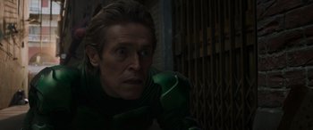 Movie still from “Spider-Man: No Way Home” (2021), directed by Jon Watts – Willem dafoe in a green outfit; Close Up shot, High angle