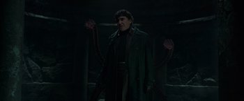 Movie still from “Spider-Man: No Way Home” (2021), directed by Jon Watts – A man in a trench coat and gloves standing in a dark room; Medium shot, Low angle
