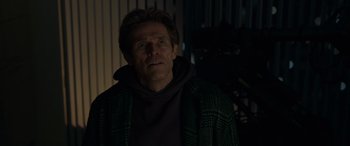 Movie still from “Spider-Man: No Way Home” (2021), directed by Jon Watts – A man in a hooded jacket looking at the camera; Medium shot, Low angle
