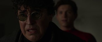 Movie still from “Spider-Man: No Way Home” (2021), directed by Jon Watts – A man with glasses and a man with glasses in the dark; Close Up shot, Over the shoulder angle