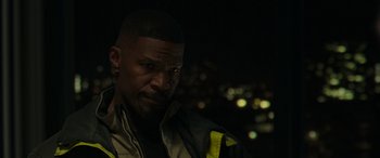 Movie still from “Spider-Man: No Way Home” (2021), directed by Jon Watts – A person wearing a jacket with lights in the background; Close Up shot, Over the shoulder angle