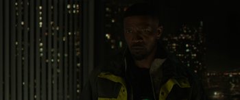 Movie still from “Spider-Man: No Way Home” (2021), directed by Jon Watts – A man in a yellow and black jacket looking at the camera; Close Up shot, Over the shoulder angle