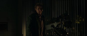 Movie still from “Spider-Man: No Way Home” (2021), directed by Jon Watts – A man standing next to a telescope in the dark; Medium shot, Low angle