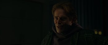 Movie still from “Spider-Man: No Way Home” (2021), directed by Jon Watts – A person wearing a green jacket; Close Up shot, Over the shoulder angle