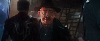 Movie still from “Spider-Man: No Way Home” (2021), directed by Jon Watts – An older man wearing a hat and a black jacket; Close Up shot, Over the shoulder angle