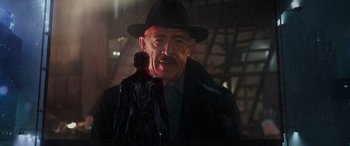 Movie still from “Spider-Man: No Way Home” (2021), directed by Jon Watts – An older man wearing a hat and a coat; Close Up shot, Over the shoulder angle