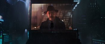 Movie still from “Spider-Man: No Way Home” (2021), directed by Jon Watts – A man standing in front of a large screen; Wide shot, Over the shoulder angle