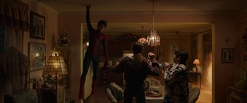 Movie still from “Spider-Man: No Way Home” (2021), directed by Jon Watts – A man dressed as spider - man standing in front of a woman; Wide shot, Low angle