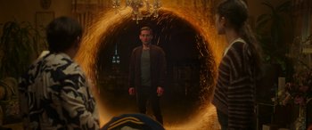 Movie still from “Spider-Man: No Way Home” (2021), directed by Jon Watts – A man standing in front of a tunnel of light; Wide shot, Over the shoulder angle