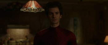 Movie still from “Spider-Man: No Way Home” (2021), directed by Jon Watts – A person wearing a red and black costume; Close Up shot, Over the shoulder angle