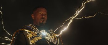 Movie still from “Spider-Man: No Way Home” (2021), directed by Jon Watts – A man in a costume is holding an electric strike; Close Up shot, Low angle