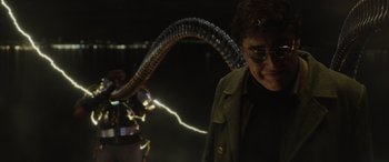 Movie still from “Spider-Man: No Way Home” (2021), directed by Jon Watts – A man standing in front of an electric snake; Medium shot, Over the shoulder angle