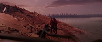 Movie still from “Spider-Man: No Way Home” (2021), directed by Jon Watts – Two people standing on a boat in front of a body of water; Wide shot, Low angle