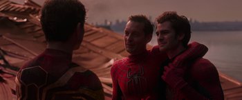 Movie still from “Spider-Man: No Way Home” (2021), directed by Jon Watts – A group of men standing next to each other on a roof; Medium shot, Over the shoulder angle