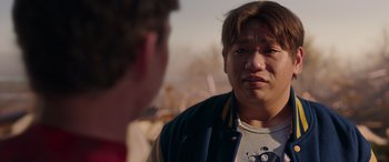 Movie still from “Spider-Man: No Way Home” (2021), directed by Jon Watts – A man in a blue and yellow jacket talking to another man in a blue and yellow jacket; Close Up shot, Over the shoulder angle