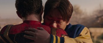 Movie still from “Spider-Man: No Way Home” (2021), directed by Jon Watts – A woman is hugging a man in a red jacket; Close Up shot, Over the shoulder angle