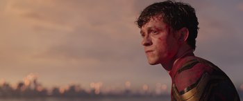 Movie still from “Spider-Man: No Way Home” (2021), directed by Jon Watts – A young man with red makeup looking into the distance; Close Up shot, Low angle