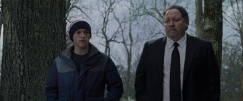 Movie still from “Spider-Man: No Way Home” (2021), directed by Jon Watts – A man and a young boy standing next to each other; Medium shot, Over the shoulder angle