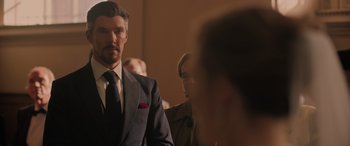 Movie still from “Spider-Man: No Way Home” (2021), directed by Jon Watts – A man wearing a suit and tie standing next to another man in a suit; Medium shot, Over the shoulder angle