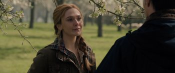 Movie still from “Spider-Man: No Way Home” (2021), directed by Jon Watts – A woman with long red hair standing next to an apple tree; Close Up shot, Over the shoulder angle