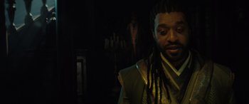 Movie still from “Spider-Man: No Way Home” (2021), directed by Jon Watts – A man with dreads standing in a dark room; Close Up shot, Over the shoulder angle