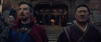 Movie still from “Spider-Man: No Way Home” (2021), directed by Jon Watts – A group of people standing in front of a building; Medium shot, Over the shoulder angle