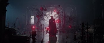 Movie still from “Spider-Man: No Way Home” (2021), directed by Jon Watts – A man in a black robe standing in front of red lights; Extreme Wide shot, Low angle