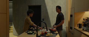 Movie still from “Spiderhead” (2022), directed by Joseph Kosinski – A man and a woman preparing food in a kitchen; Medium shot, High angle