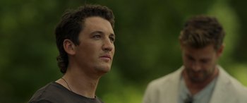 Movie still from “Spiderhead” (2022), directed by Joseph Kosinski – A person looking up at the sky; Close Up shot, Over the shoulder angle