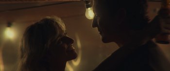 Movie still from “Spiderhead” (2022), directed by Joseph Kosinski – A man and a woman looking into each others eyes; Close Up shot, Low angle