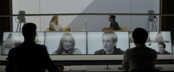 Movie still from “Spiderhead” (2022), directed by Joseph Kosinski – A man and a woman sitting in front of a computer screen; Medium shot, Over the shoulder angle