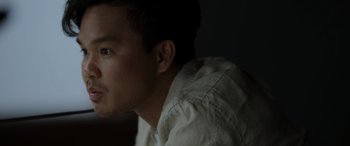 Movie still from “Spiderhead” (2022), directed by Joseph Kosinski – A person wearing a white shirt; Close Up shot, Low angle