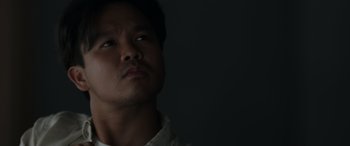 Movie still from “Spiderhead” (2022), directed by Joseph Kosinski – A person looking up at the sky; Close Up shot, Low angle