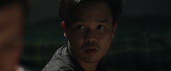 Movie still from “Spiderhead” (2022), directed by Joseph Kosinski – A person wearing a black shirt; Close Up shot, Low angle