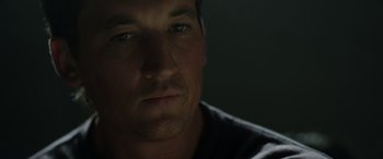 Movie still from “Spiderhead” (2022), directed by Joseph Kosinski – A man's face in the dark; Close Up shot, Low angle