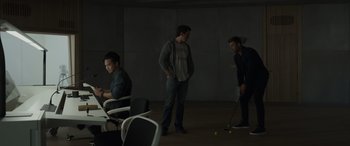 Movie still from “Spiderhead” (2022), directed by Joseph Kosinski – A group of people standing around a room; Wide shot, Over the shoulder angle
