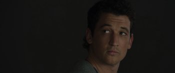 Movie still from “Spiderhead” (2022), directed by Joseph Kosinski – A person looking at the camera; Close Up shot, Over the shoulder angle