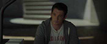 Movie still from “Spiderhead” (2022), directed by Joseph Kosinski – A person wearing a hoodie; Close Up shot, Over the shoulder angle