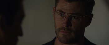 Movie still from “Spiderhead” (2022), directed by Joseph Kosinski – A person wearing glasses; Close Up shot, Over the shoulder angle