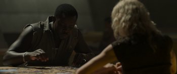 Movie still from “Spiderhead” (2022), directed by Joseph Kosinski – A man and a woman are playing a puzzle game together; Close Up shot, Over the shoulder angle