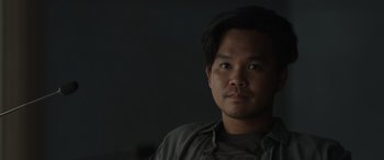 Movie still from “Spiderhead” (2022), directed by Joseph Kosinski – A person wearing a gray shirt; Close Up shot, Low angle