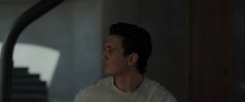 Movie still from “Spiderhead” (2022), directed by Joseph Kosinski – A person looking to the side; Close Up shot, Low angle