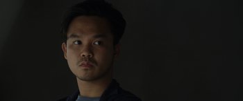 Movie still from “Spiderhead” (2022), directed by Joseph Kosinski – A person wearing a blue shirt; Close Up shot, Low angle