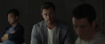 Movie still from “Spiderhead” (2022), directed by Joseph Kosinski – A person wearing a jacket; Close Up shot, Over the shoulder angle