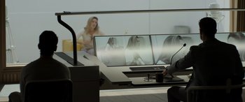 Movie still from “Spiderhead” (2022), directed by Joseph Kosinski – Two people sitting in front of two computer monitors; Medium shot, Over the shoulder angle