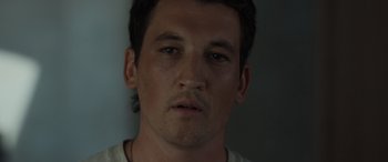 Movie still from “Spiderhead” (2022), directed by Joseph Kosinski – A man's face in a dark room; Close Up shot, Low angle